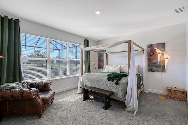 carpeted bedroom with visible vents and baseboards