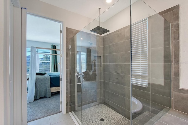 full bathroom featuring a stall shower, tile patterned flooring, and ensuite bathroom