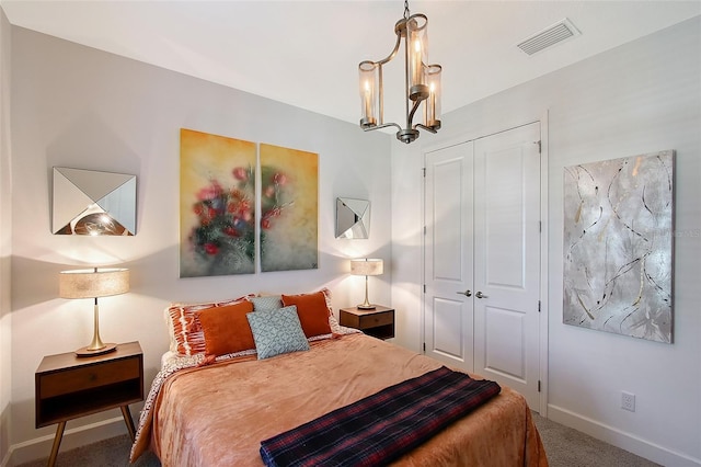 bedroom featuring a notable chandelier, a closet, visible vents, carpet flooring, and baseboards