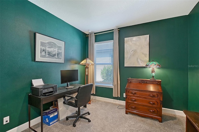 carpeted home office featuring baseboards