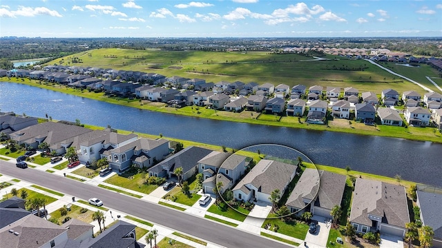 birds eye view of property with a water view and a residential view