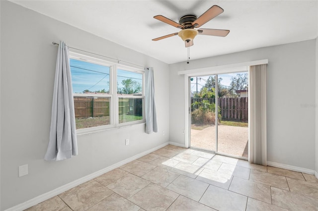 unfurnished room with light tile patterned floors, baseboards, and a ceiling fan