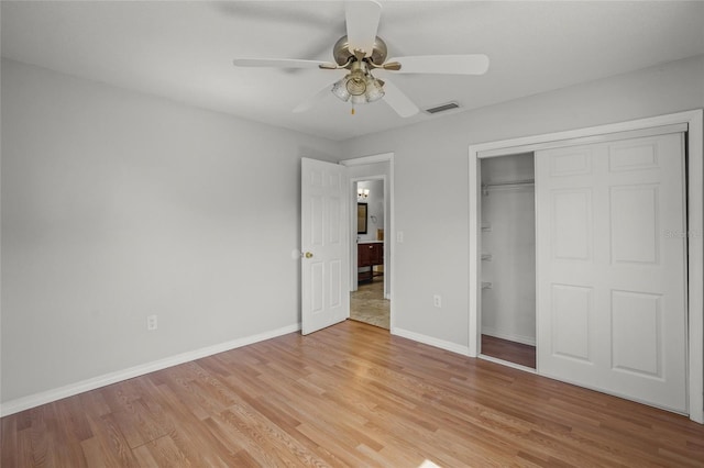 unfurnished bedroom featuring a closet, baseboards, visible vents, and light wood finished floors