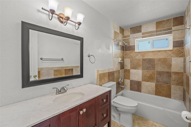 full bath featuring bathing tub / shower combination, toilet, vanity, a textured ceiling, and tile patterned flooring