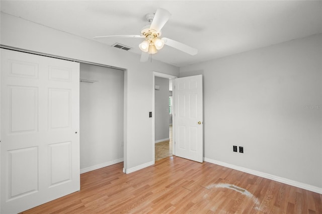 unfurnished bedroom with a ceiling fan, baseboards, visible vents, light wood-style floors, and a closet