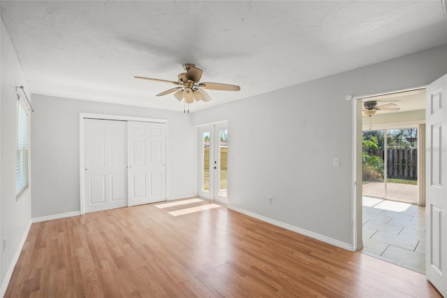 unfurnished bedroom with access to outside, light wood-style flooring, and french doors