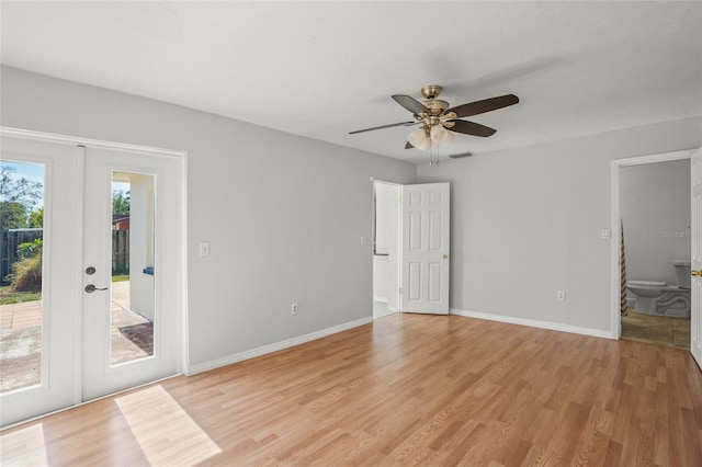 spare room with a ceiling fan, french doors, light wood-style flooring, and baseboards