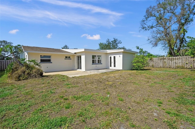 back of house featuring a patio, french doors, fence, and stucco siding