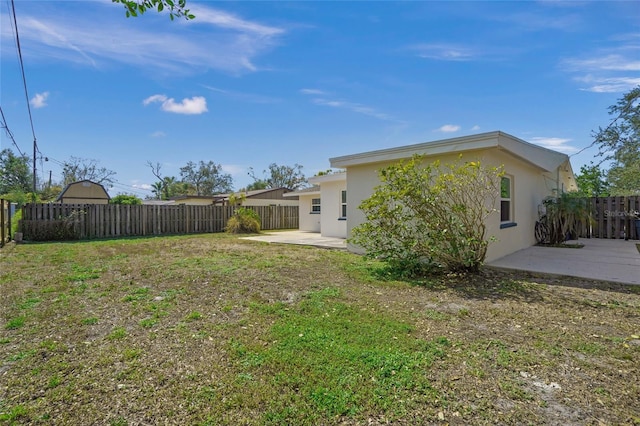 view of yard with a fenced backyard and a patio