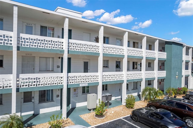 view of building exterior with uncovered parking