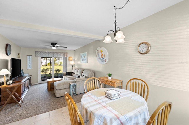 dining area with light carpet, light tile patterned floors, beamed ceiling, and ceiling fan with notable chandelier