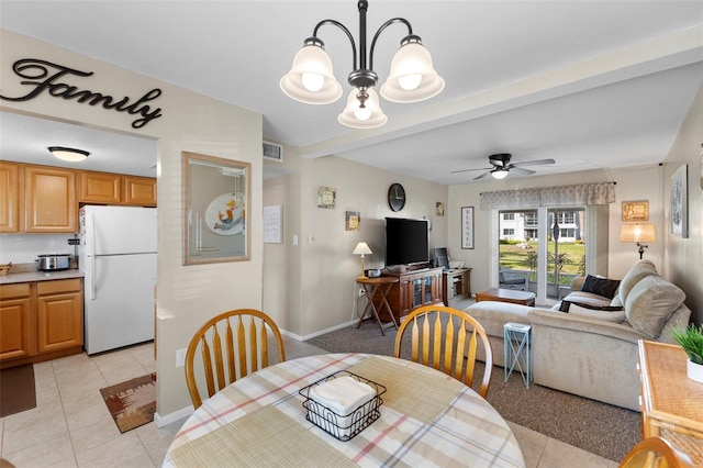 dining area with beam ceiling, light tile patterned flooring, visible vents, and ceiling fan with notable chandelier