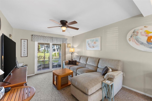 carpeted living room featuring a ceiling fan and baseboards