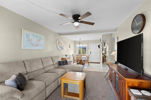 living area with a ceiling fan and light tile patterned floors