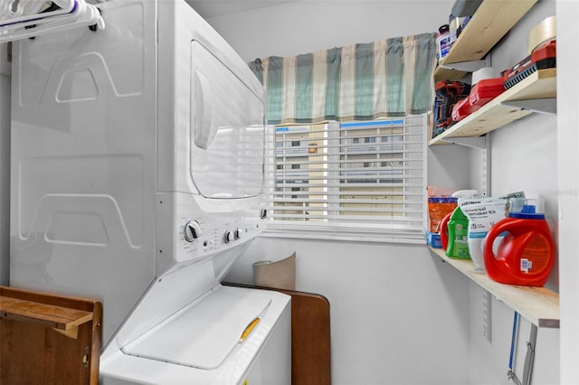 laundry room featuring laundry area and stacked washer / drying machine