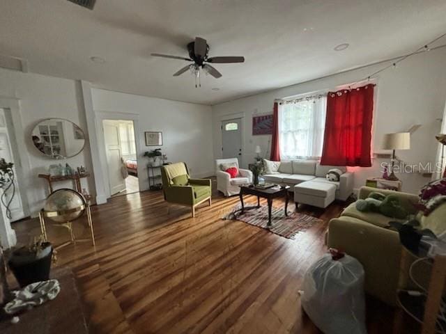 living room featuring a ceiling fan and wood finished floors