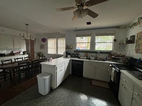 kitchen featuring visible vents, hanging light fixtures, white cabinetry, a peninsula, and black appliances