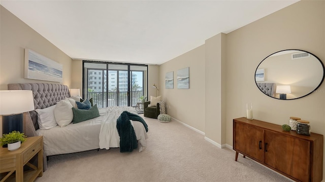 bedroom with visible vents, baseboards, light colored carpet, access to outside, and floor to ceiling windows