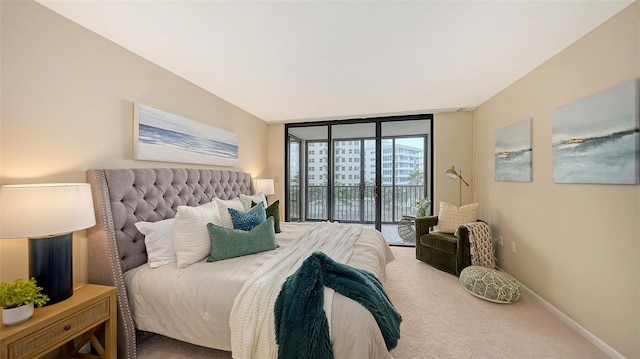 bedroom featuring carpet floors, expansive windows, access to exterior, and baseboards