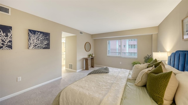 bedroom with light carpet, baseboards, and visible vents