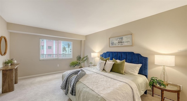 carpeted bedroom featuring baseboards