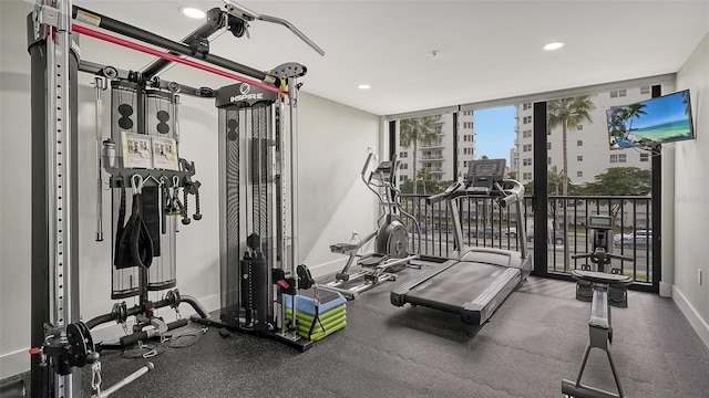 exercise area featuring expansive windows, baseboards, and recessed lighting