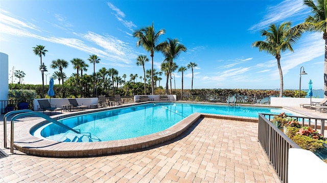 pool featuring a patio area and fence