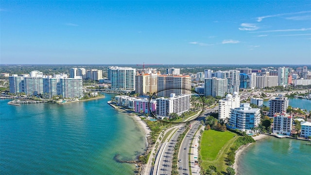 birds eye view of property with a view of city and a water view