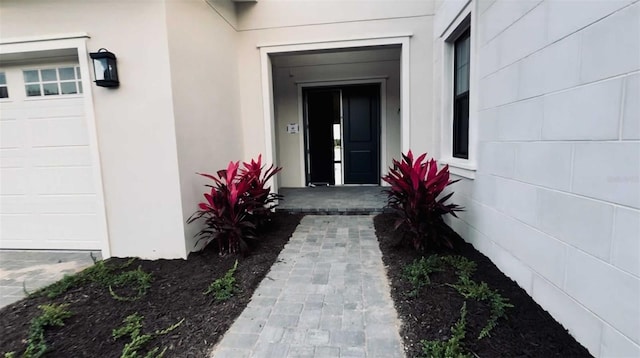 entrance to property featuring concrete block siding