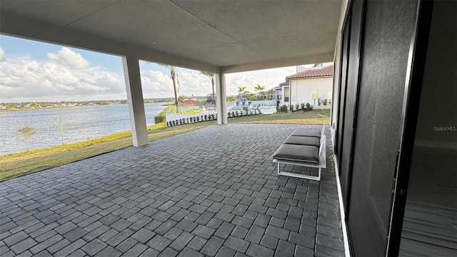 view of patio with a water view