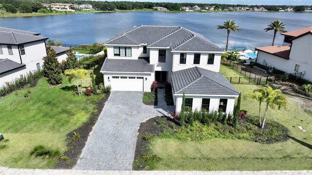 16832 Bolsena Dr, Bella Collina, FL 34756 - view of front of home with a tile roof, decorative driveway, a water view, and stucco siding