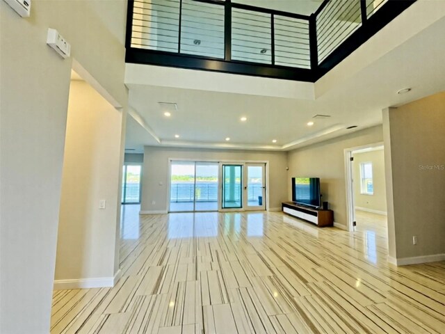16832 Bolsena Dr, Bella Collina, FL 34756 - unfurnished living room with baseboards, recessed lighting, and a towering ceiling