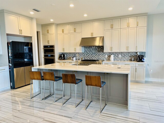 16832 Bolsena Dr, Bella Collina, FL 34756 - kitchen featuring stainless steel appliances, under cabinet range hood, a sink, tasteful backsplash, and recessed lighting