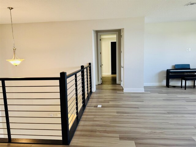 16832 Bolsena Dr, Bella Collina, FL 34756 - hallway with light wood-style floors and baseboards