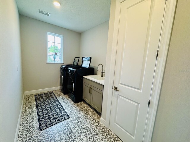 16832 Bolsena Dr, Bella Collina, FL 34756 - laundry room featuring washer and dryer, cabinet space, baseboards, and a textured ceiling