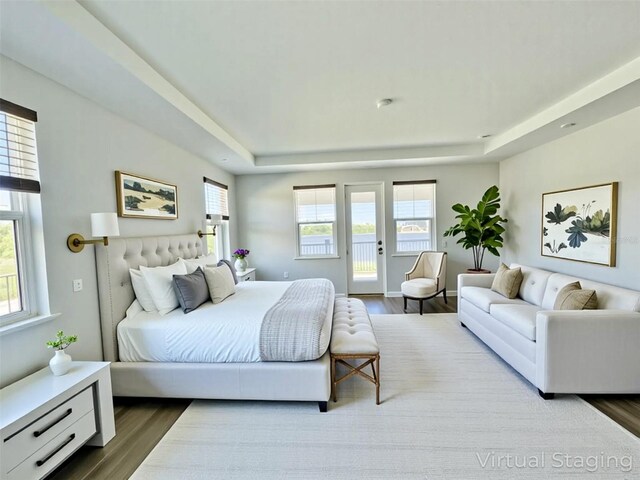 16832 Bolsena Dr, Bella Collina, FL 34756 - bedroom featuring a raised ceiling, access to outside, and wood finished floors