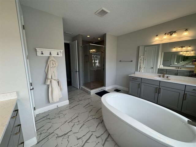 16832 Bolsena Dr, Bella Collina, FL 34756 - full bathroom featuring marble finish floors, baseboards, vanity, a stall shower, and a textured ceiling