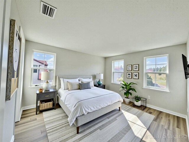 16832 Bolsena Dr, Bella Collina, FL 34756 - bedroom featuring light wood-style flooring and baseboards