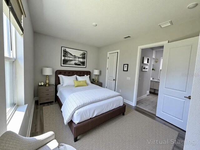 16832 Bolsena Dr, Bella Collina, FL 34756 - bedroom with wood finished floors, baseboards, and ensuite bathroom