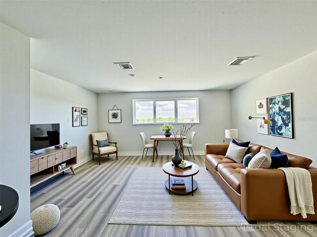 16832 Bolsena Dr, Bella Collina, FL 34756 - living room featuring wood finished floors and baseboards