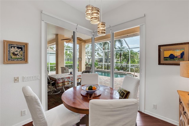 dining area featuring dark wood-style floors and baseboards