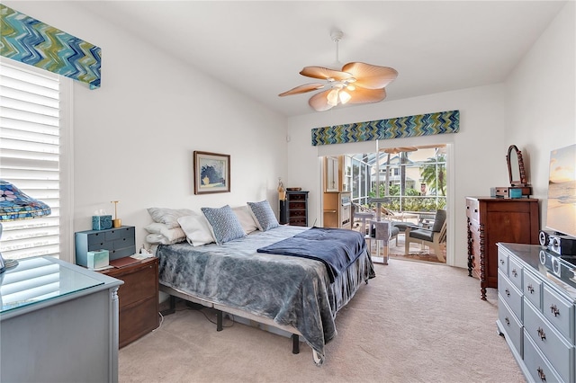 bedroom featuring access to exterior, light carpet, and a ceiling fan