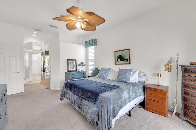 bedroom with multiple windows, light colored carpet, and visible vents