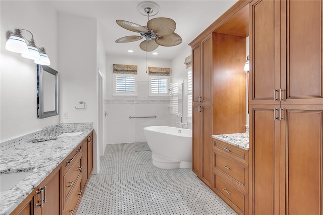 full bathroom featuring ceiling fan, a freestanding bath, vanity, tiled shower, and tile walls