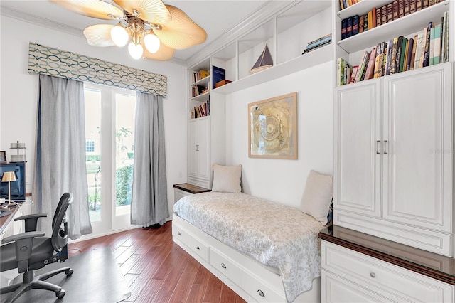 bedroom featuring crown molding and wood finished floors