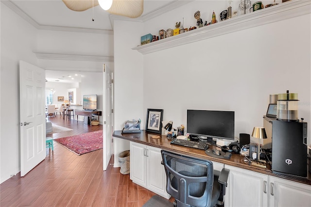 office area featuring ceiling fan, light wood-type flooring, and ornamental molding