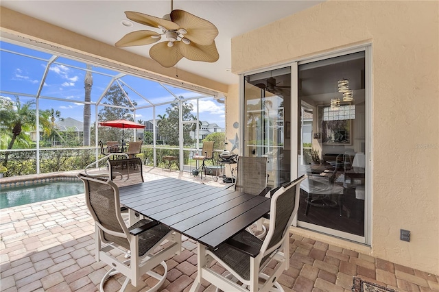 sunroom / solarium with a ceiling fan