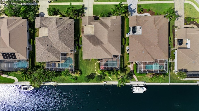 drone / aerial view with a residential view and a water view