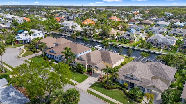 drone / aerial view featuring a residential view and a water view