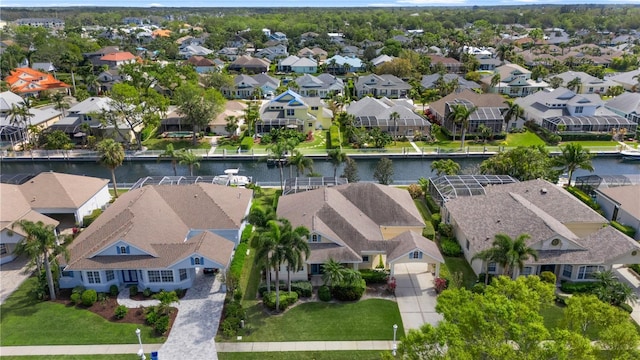 drone / aerial view featuring a residential view and a water view